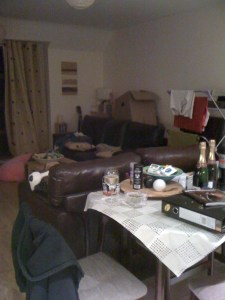 A living room with lots of items scattered around it